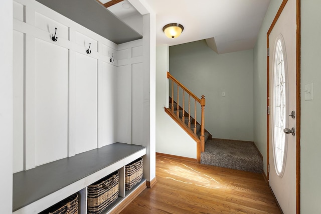 mudroom with a healthy amount of sunlight, baseboards, and wood finished floors