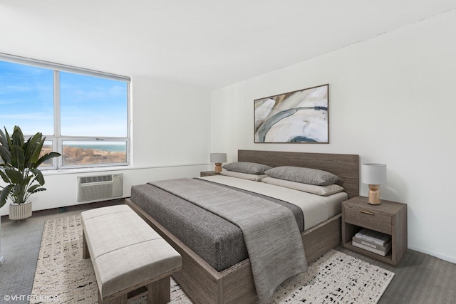 bedroom with a wall mounted AC and carpet flooring