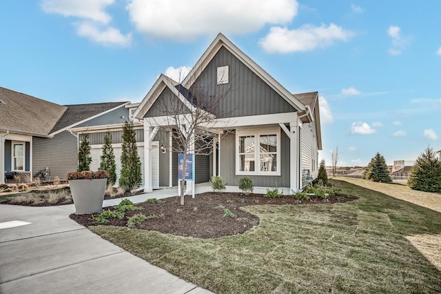 view of front facade with an attached garage, a front lawn, board and batten siding, and concrete driveway