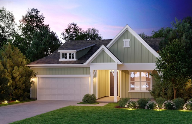 view of front of house featuring a garage, driveway, board and batten siding, and a lawn