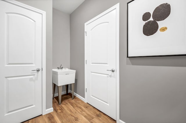 interior space featuring light wood-type flooring and baseboards