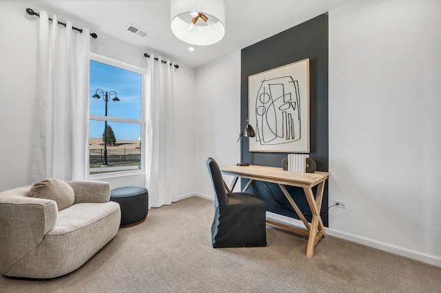 carpeted office featuring visible vents and baseboards