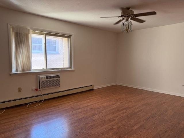 empty room featuring baseboards, a baseboard radiator, a ceiling fan, and wood finished floors