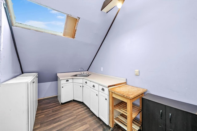 interior space featuring light countertops, dark wood-style flooring, white cabinetry, and a sink