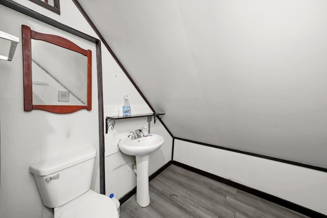 bathroom featuring a sink, toilet, and wood finished floors