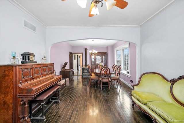 sitting room featuring ceiling fan with notable chandelier, dark wood-style flooring, visible vents, and crown molding