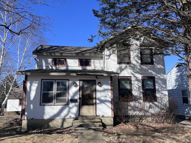 traditional home featuring entry steps