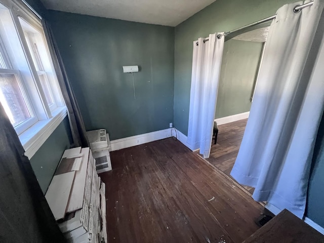 interior space with baseboards and wood finished floors