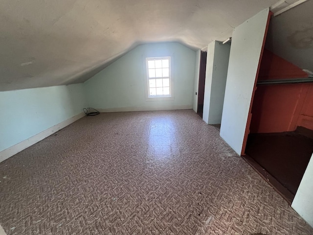 additional living space featuring vaulted ceiling