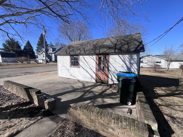 exterior space with a shingled roof