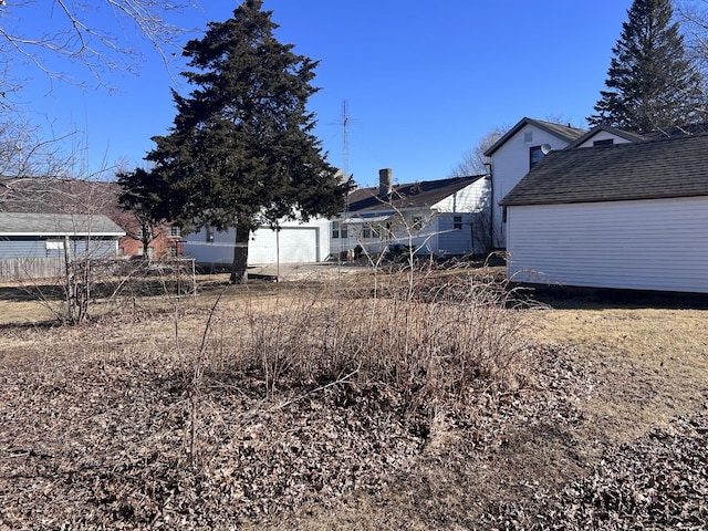 view of yard featuring a garage and fence