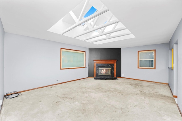 unfurnished living room featuring a high end fireplace and baseboards