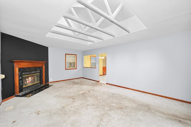 unfurnished living room featuring a fireplace and baseboards