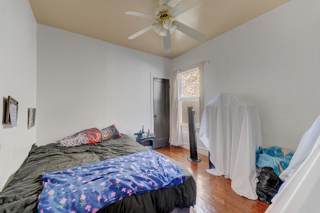 bedroom featuring a ceiling fan and wood finished floors