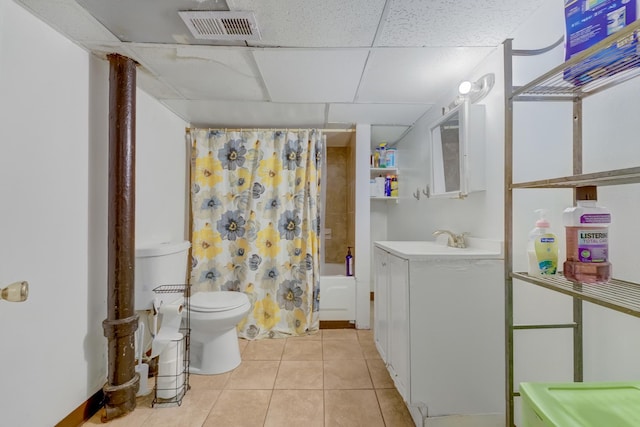 bathroom featuring a paneled ceiling, visible vents, shower / bathtub combination with curtain, toilet, and tile patterned flooring