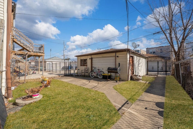 detached garage with fence and a gate