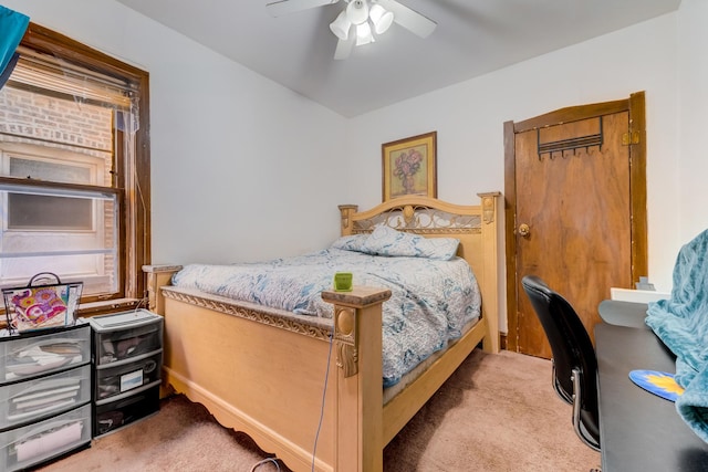 bedroom with a ceiling fan and light colored carpet