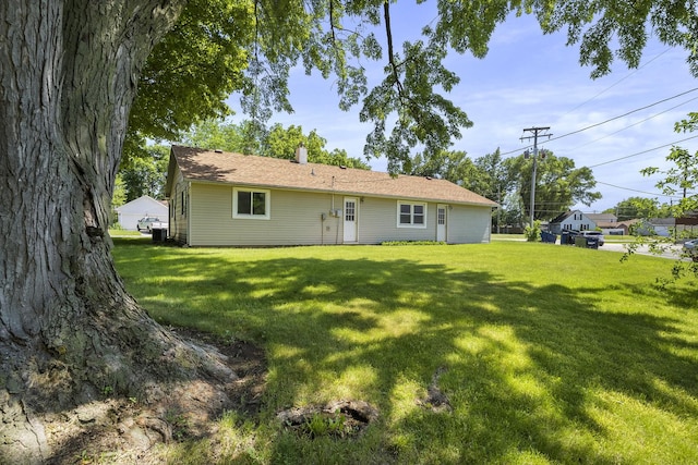 back of house with a lawn