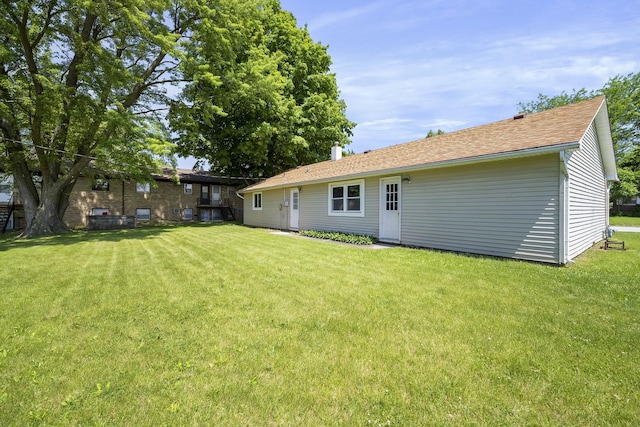 back of house with a yard