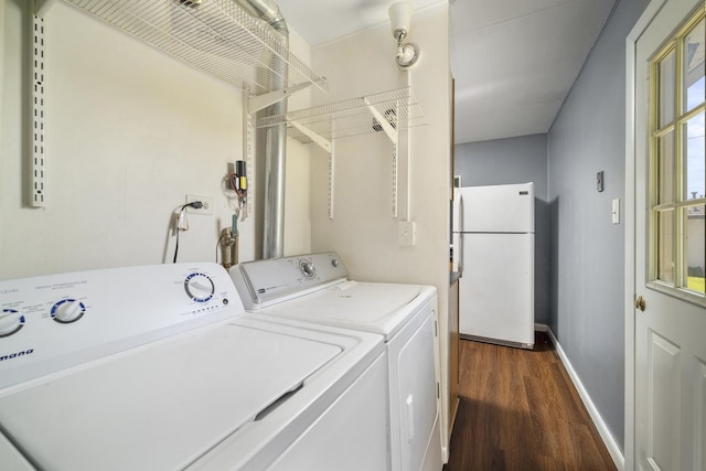 laundry area with laundry area, baseboards, independent washer and dryer, and dark wood-style flooring