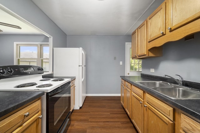 kitchen with electric range oven, a sink, a wealth of natural light, and dark wood-style floors