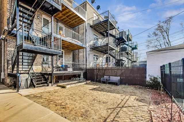 exterior space featuring fence and brick siding