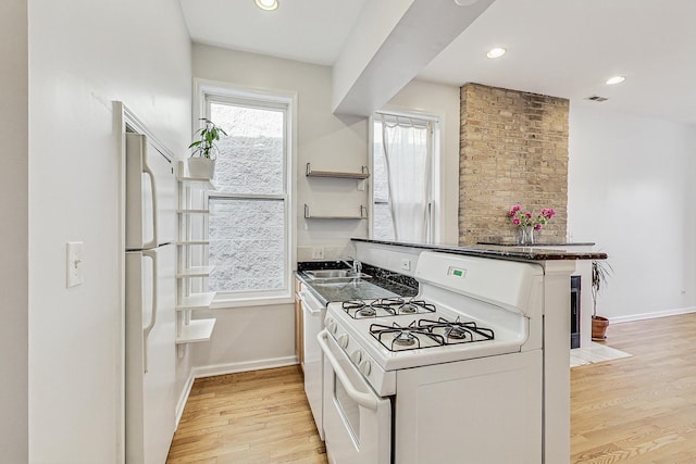 kitchen with light wood-type flooring, white appliances, baseboards, and recessed lighting