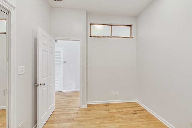 empty room with light wood-style floors and baseboards