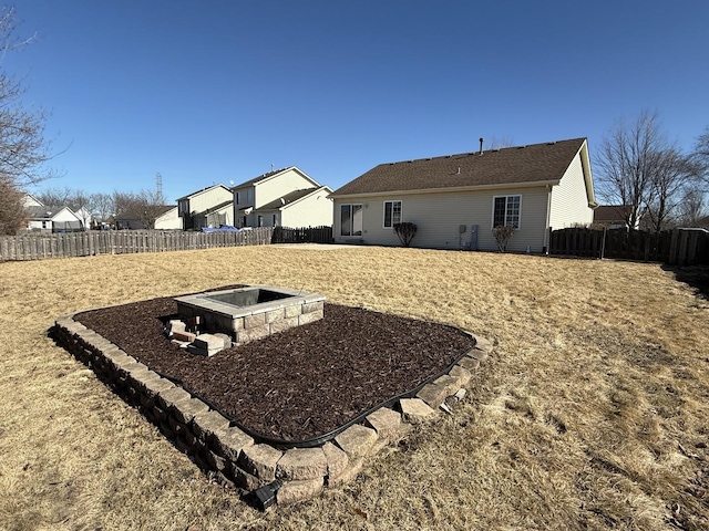 exterior space with a fire pit and a fenced backyard