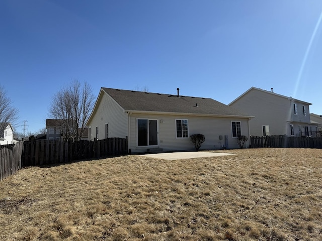 back of property with a patio and fence