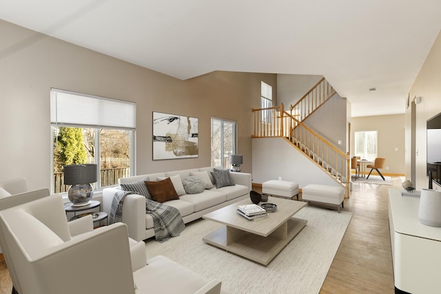 living area featuring light wood-type flooring and stairway