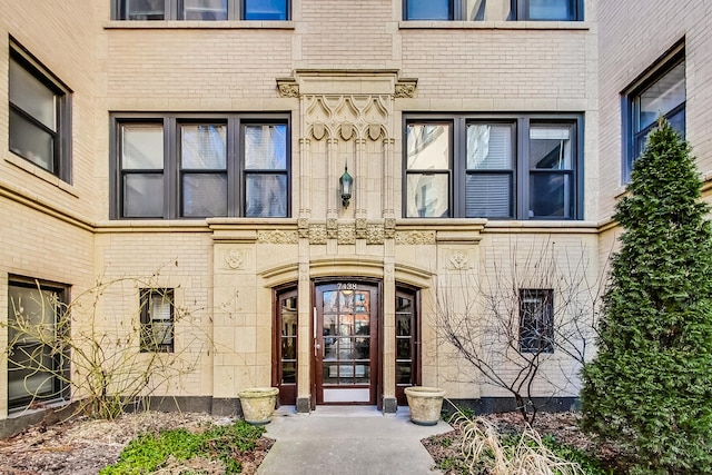 doorway to property with brick siding