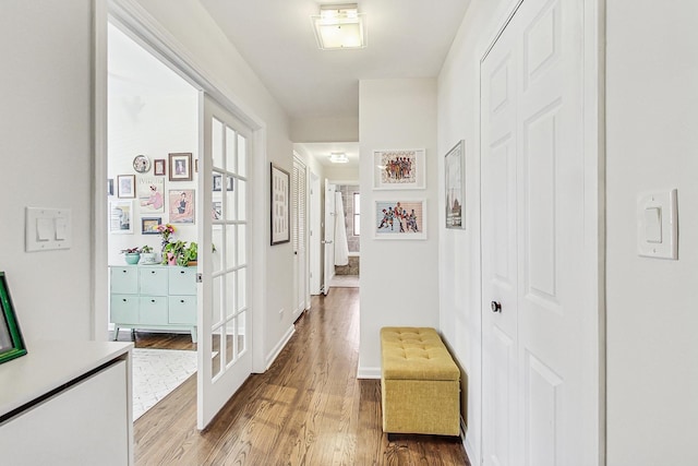 hall with light wood-style floors and french doors