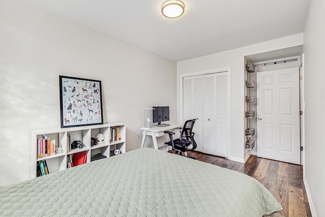 bedroom with a closet, wood finished floors, and baseboards