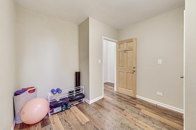 interior space with baseboards and wood finished floors