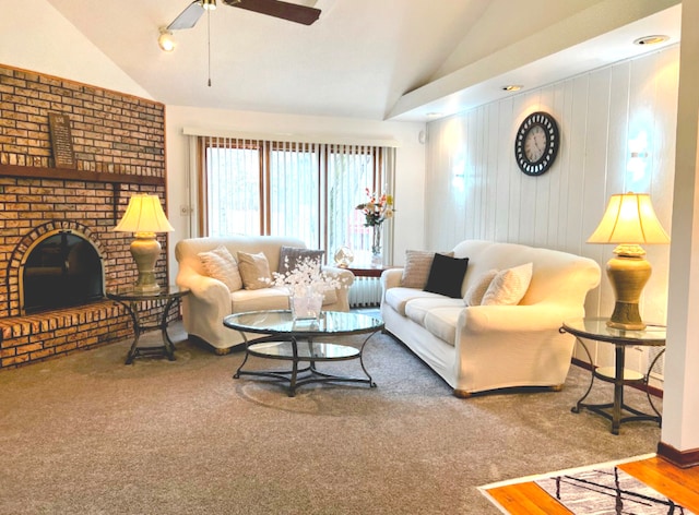 living area featuring lofted ceiling, ceiling fan, a fireplace, and wooden walls