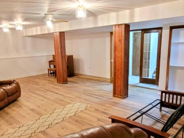 interior space featuring light wood-style floors, ceiling fan, and baseboards