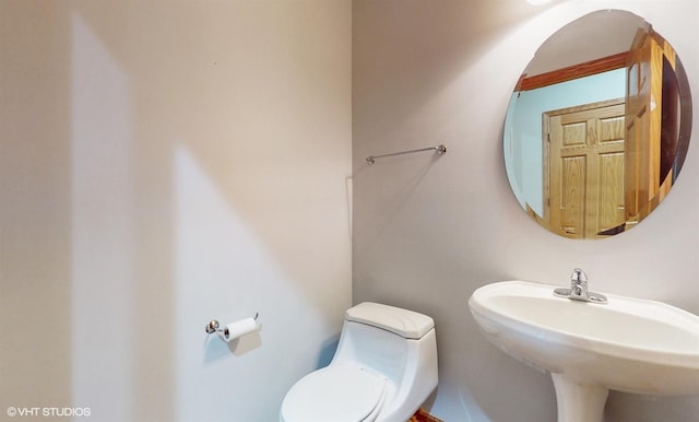 bathroom featuring toilet and a sink