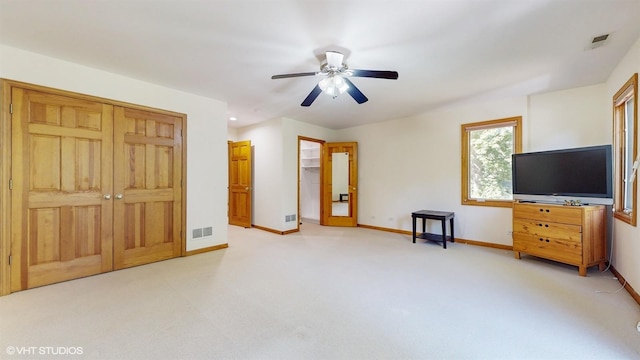 unfurnished bedroom featuring a closet, visible vents, light carpet, and baseboards