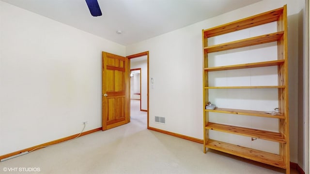 unfurnished bedroom with a ceiling fan, baseboards, visible vents, and carpet flooring