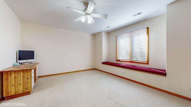 carpeted empty room featuring ceiling fan, visible vents, and baseboards