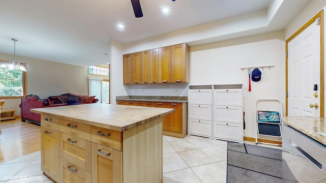 kitchen featuring open floor plan, butcher block countertops, light tile patterned floors, and plenty of natural light