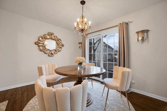 dining room with an inviting chandelier, wood finished floors, and baseboards