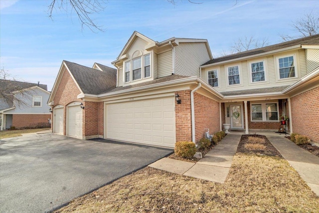 traditional-style house featuring brick siding and driveway