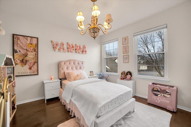 bedroom featuring dark wood finished floors, a notable chandelier, visible vents, and baseboards