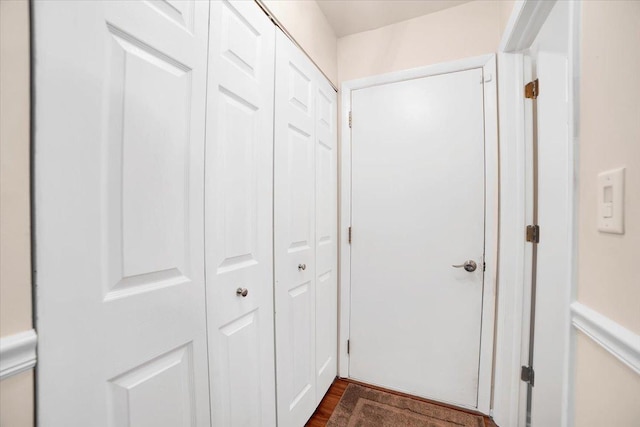 corridor featuring dark wood finished floors