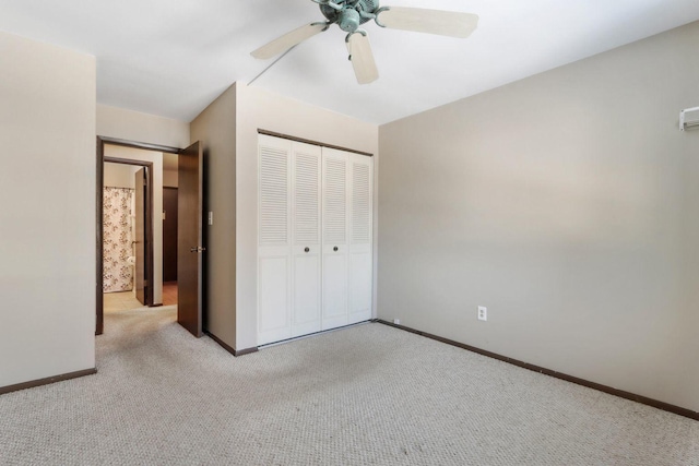 unfurnished bedroom featuring a ceiling fan, carpet, a closet, and baseboards