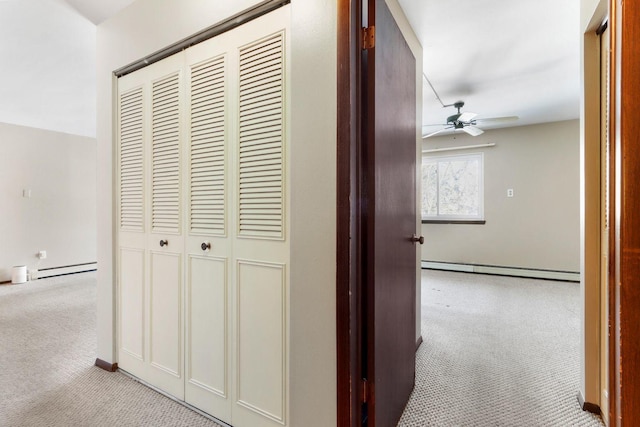 corridor with carpet floors, a baseboard radiator, and baseboard heating