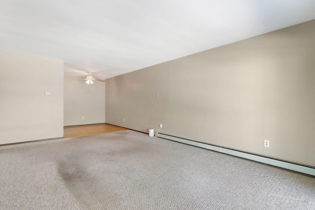 empty room with a ceiling fan, a baseboard radiator, light carpet, and baseboards