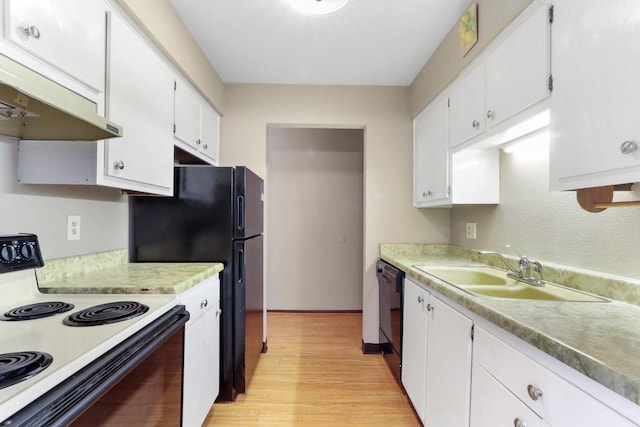 kitchen featuring under cabinet range hood, range with electric cooktop, a sink, light wood-style floors, and white cabinets